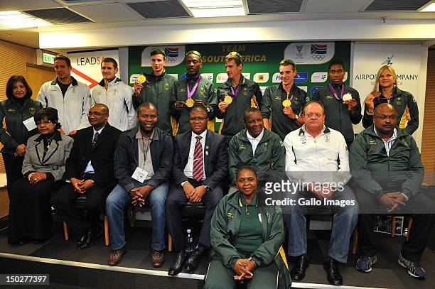 Medal winners including Chad le Clos pose with dignitaries during the South African Olympic team arrival and press conference at OR Tambo...