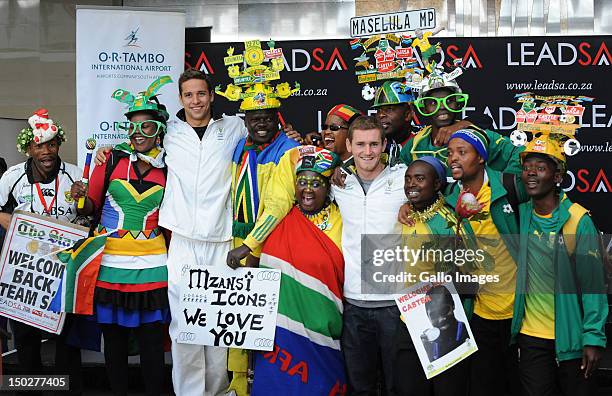 Medal winners Chad le Clos and Cameron van der Burgh pose with fans during the South African Olympic team arrival and press conference at OR Tambo...