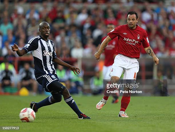 Andy Reid of Nottingham Forest plays the ball past Youssouf Mulumbu of West Bromwich Albion during the Pre Season Friendly match between Nottingham...