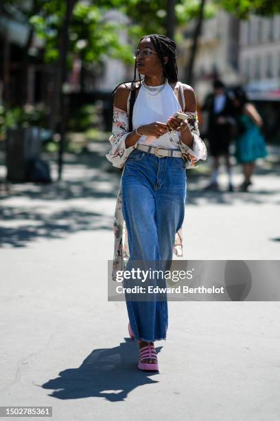 Guest wears white transparent and blue glasses, a white halter-neck tank-top, a white with green and red flower print pattern silk long kimono, a...