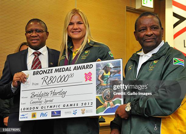 Medal winner Bridgitte Hartley poses with Fikile Mlalula and Gideon Sam during the South African Olympic team arrival and press conference at OR...