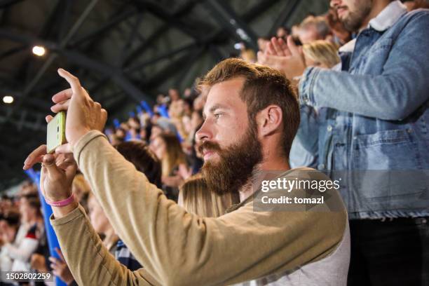 man photographing at a footbal match - supporter selfie stock pictures, royalty-free photos & images