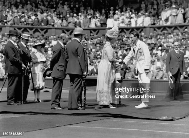 Wimbledon tennis champion Jean Borotra from France is presented to King George V and Queen Mary , Queen Consort on Centre Court at the opening...