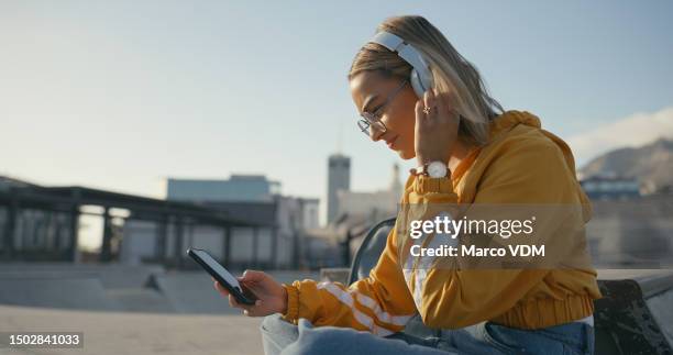 music, headphones and gen z girl with phone on a rooftop for audio, search or streaming outdoor. earphones, smartphone and female student relax with podcast, radio or online subscription or app - z com stock pictures, royalty-free photos & images