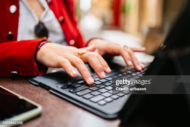 young businesswoman working on a laptop in a sidewalk café in valletta malta - malta business stock pictures, royalty-free photos & images