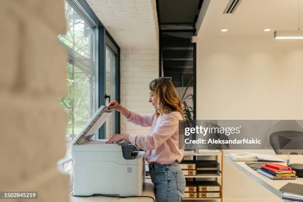 young woman in the office - photocopier stock pictures, royalty-free photos & images