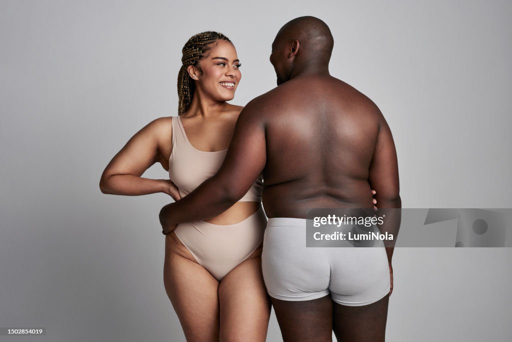 Happy Plus Size And Couple Hug In Studio In Underwear For Wellness Health  And Skincare Natural Beauty And African Man And Woman Embrace On Gray  Background For Body Positivity Care And Love