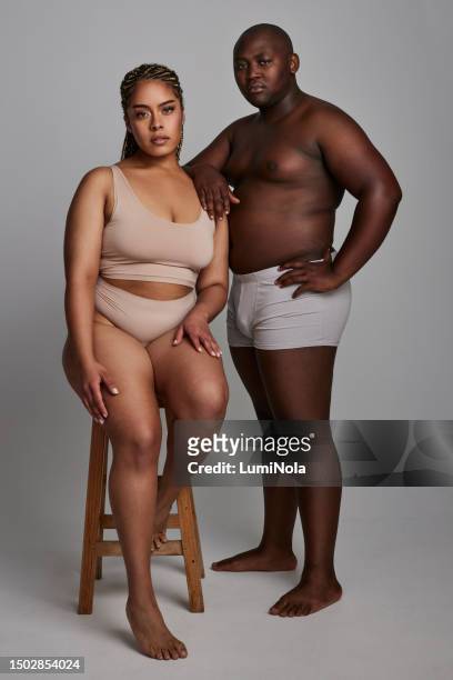 plus size couple, portrait with body positivity and self love, beauty and wellness on studio background. support with people in underwear and trust, health and empowerment, equality and acceptance - men underware model stock pictures, royalty-free photos & images