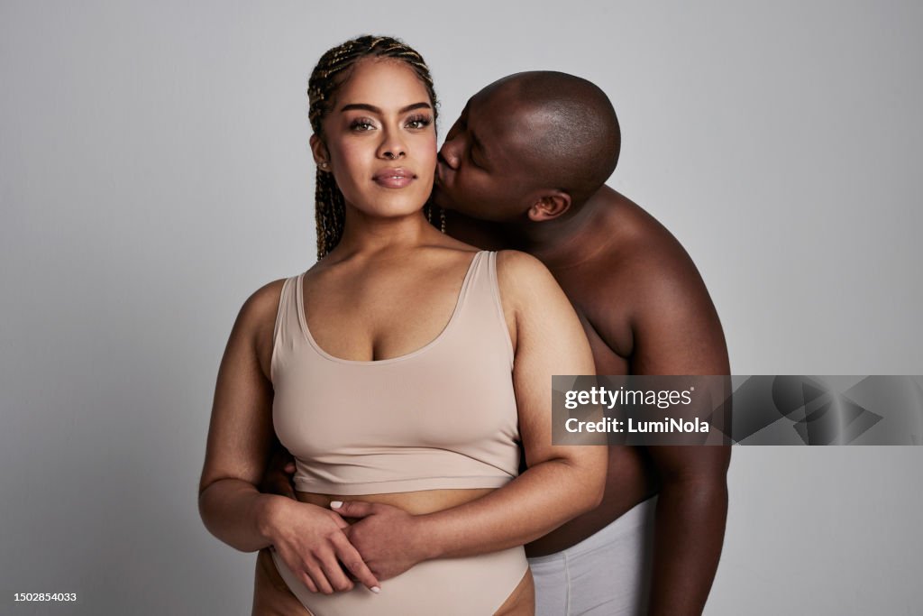Plus Size Kissing And Portrait Of Couple In Studio In Underwear For  Wellness Health And Skincare Natural Beauty And African Man And Woman On  Gray Background For Body Positivity Care And Love