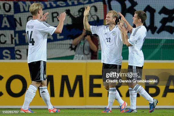 Maximilian Beister of Germany celebrates with teammates Sebastian Polter and Sebastian Jung after scoring his team's first goal during the Under 21...