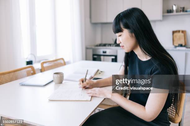 female asian freelancer writer working from home. - escritura japonesa imagens e fotografias de stock