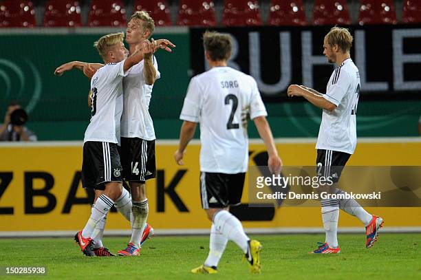 Lewis Holtby of Germany celebrates with teammates after scoring his team's second goal during the Under 21 international friendly match between...