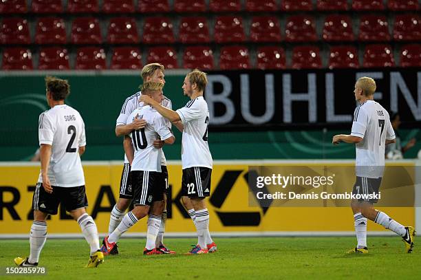 Lewis Holtby of Germany celebrates with teammates after scoring his team's second goal during the Under 21 international friendly match between...