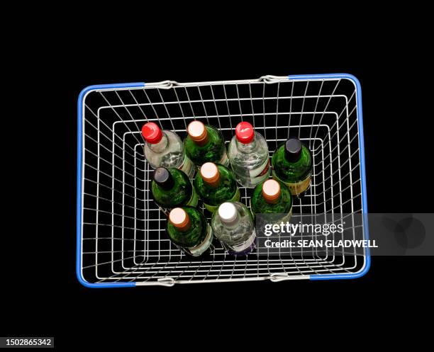 wine bottles in shopping basket - shopping basket above stock pictures, royalty-free photos & images
