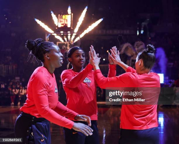 Chelsea Gray, Jackie Young and Kelsey Plum of the Las Vegas Aces are introduced before their game against the Indiana Fever at Michelob ULTRA Arena...