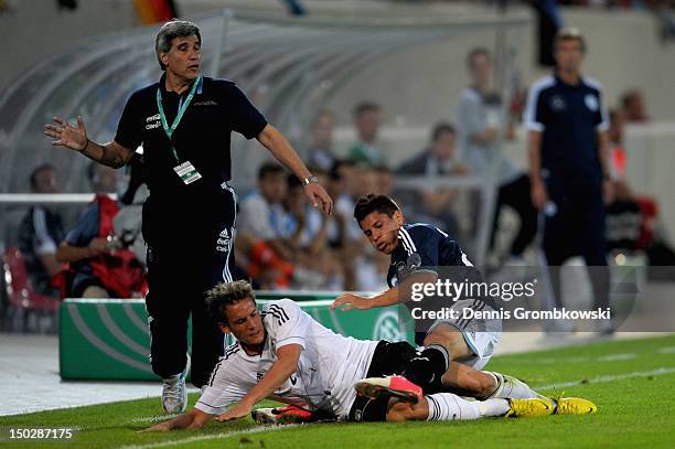 Juan Manuel Iturbe of Argentina and Oliver Sorg of Germany battle for the ball during the Under 21 international friendly match between Germany U21...