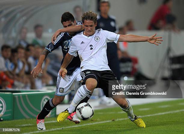 Juan Manuel Iturbe of Argentina and Oliver Sorg of Germany battle for the ball during the Under 21 international friendly match between Germany U21...