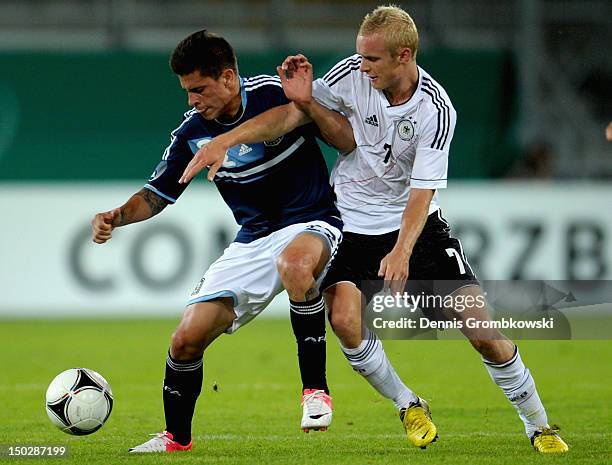 Juan Manuel Iturbe of Argentina and Sebastian Rode of Germany battle for the ball during the Under 21 international friendly match between Germany...