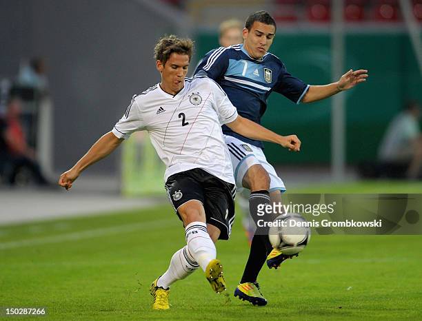 Oliver Sorg of Germany and Franco Fragapane of Argentina battle for the ball during the Under 21 international friendly match between Germany U21 and...