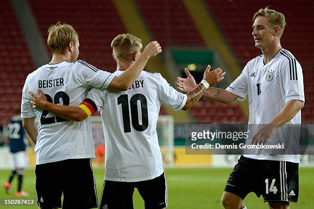 Maximilian Beister of Germany celebrates with teammates after scoring his team's third goal during the Under 21 international friendly match between...