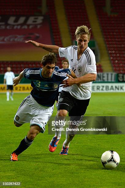 Lucas Rodriguez of Argentina and Sebastian Polter of Germany battle for the ball during the Under 21 international friendly match between Germany U21...