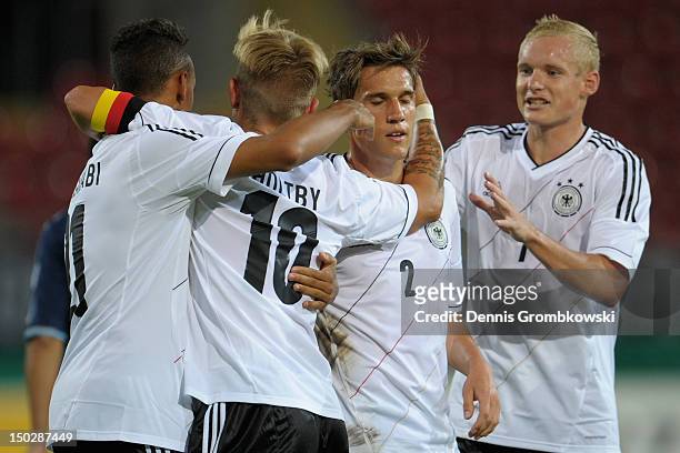 Lewis Holtby of Germany celebrates with teammates after scoring his team's fourth goal during the Under 21 international friendly match between...