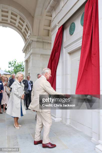 King Charles III and Queen Camilla unveil the plague for the Queen Mother Square and Royal Pavillion as they visit Poundbury at Poundbury on June 27,...