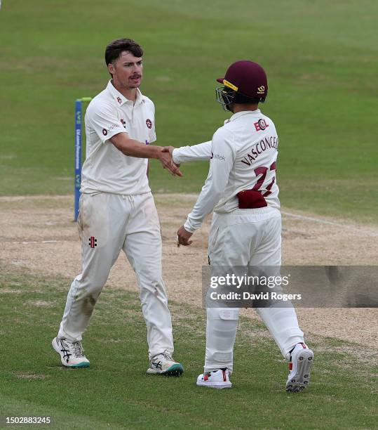 Alex Russell of Northamptonshire is congratulated by team mate Ricardo Vasconcelos after taking six wickets in the innings during the LV= Insurance...