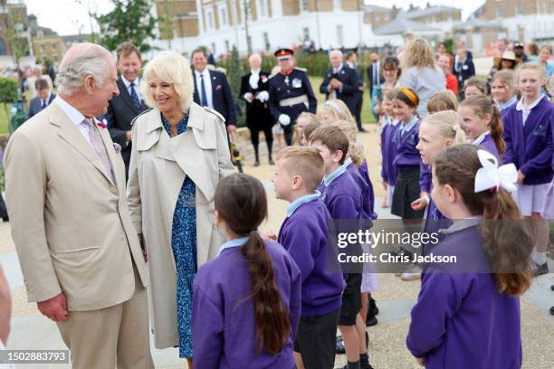 King Charles III and Queen Camilla meet children from local Damers First School who performed their Coronation song as they visit Poundbury at...