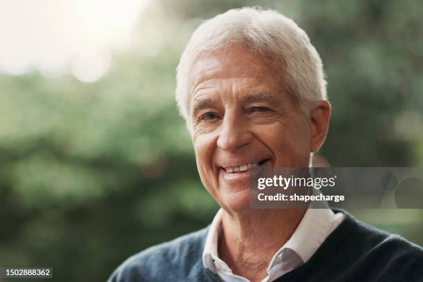 senior man, smile and happy portrait outdoor at a park or backyard for freedom, peace and wellness. headshot and face of elderly male person for retirement lifestyle, positive mindset and motivation - green inspiring backgrounds imagens e fotografias de stock