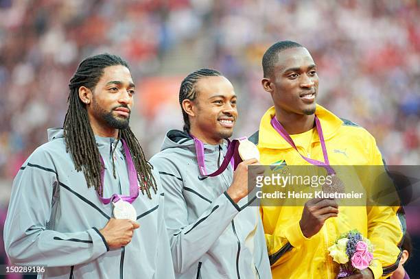Summer Olympics: USA Aries Merritt victorious with USA Jason Richardson and Jamaica Hansle Parchment on medal stand after winning Men's 110M Hurdles...