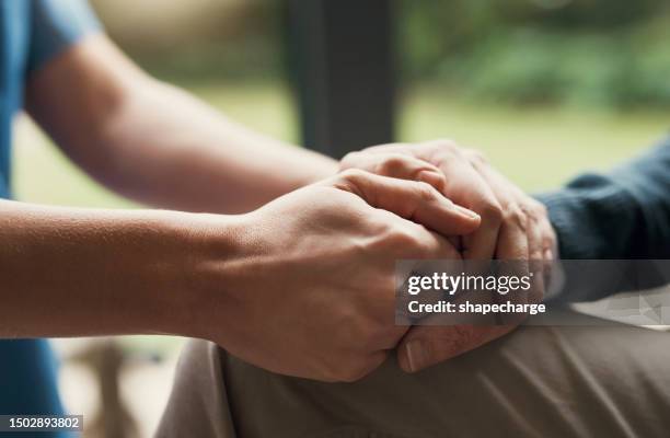 closeup, hands and support with hope, empathy and praying with trust, healing together and grief. zoom, elderly woman and person touching palms, compassion or sympathy with bonding, comfort and loss - perdão imagens e fotografias de stock