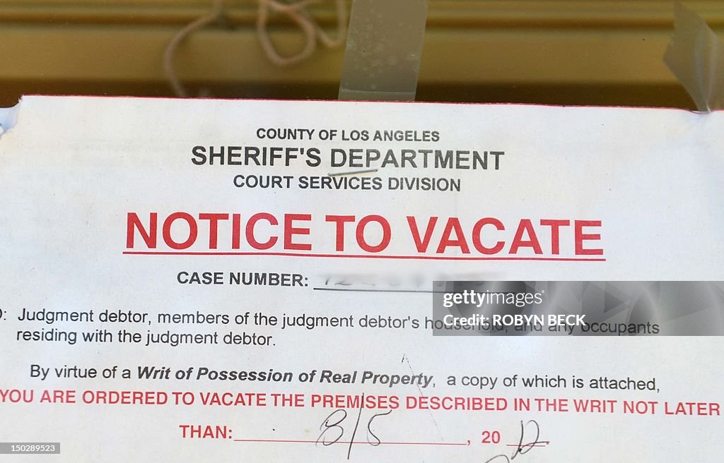 A "Notice to Vacate" is seen in the wind