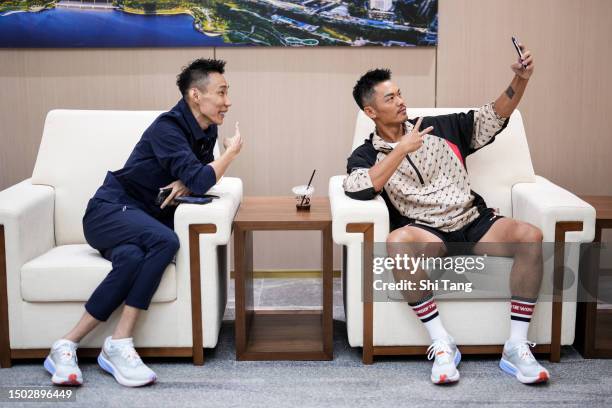 Lin Dan of China and Lee Chongwei of Malaysia take a selfie during the Mix & Match event on June 27, 2023 in Shenzhen, China.