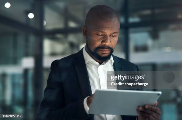 black man, night with tablet and business, technology and research for legal case with lawyer in office. attorney, digital archive search and male advocate with touchscreen, law firm and reading info - law firm stock pictures, royalty-free photos & images