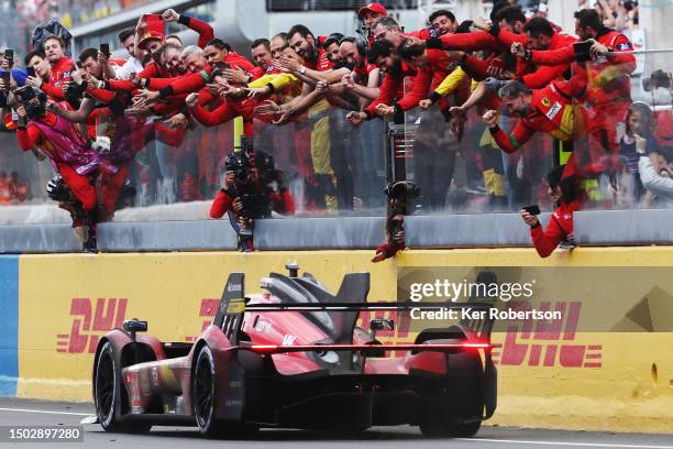 The race winning Ferrari AF Corse Ferrari 499P of Alessandro Pier Guidi , James Calado and Antonio Giovinazzi passes celebrating team on the pit wall...