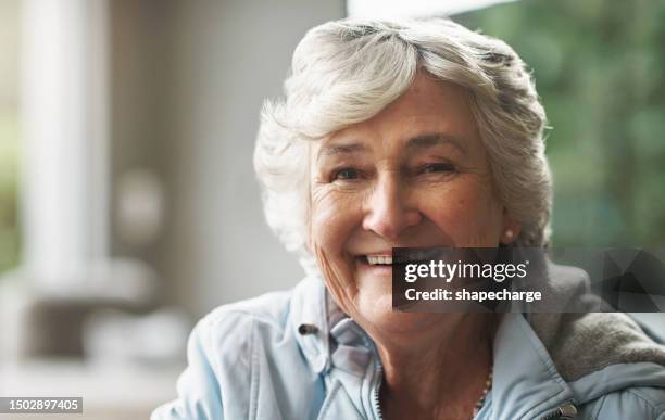 happy, relax and portrait of a senior woman in a house for comfort, peace and retirement. smile, face and a beautiful elderly person in a living room of a lounge with confidence in a nursing home - charmig bildbanksfoton och bilder