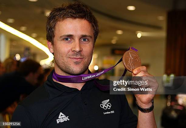 Simon van Velthooven of the New Zealand Olympic team poses with his Bronze medal after arriving at Auckland International Airport after competing in...