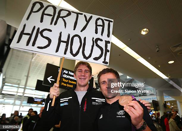 Simon van Velthooven of the New Zealand Olympic team poses with a fan after arriving at Auckland International Airport after competing in the 2012...