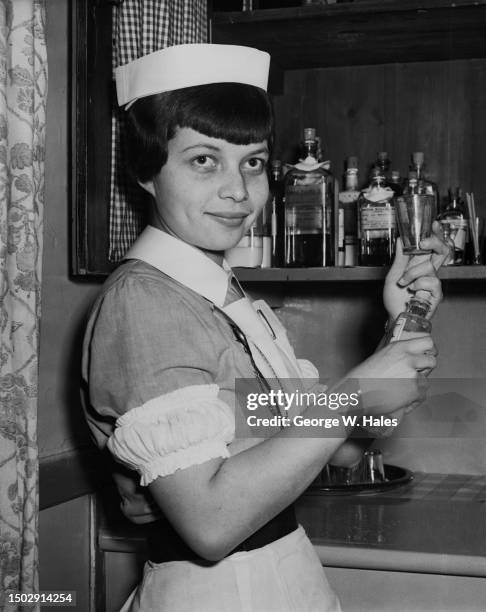 Dutch-Indonesian nurse Kitty Leontina Maria Pennock, a staff nurse, mixing medicine at Queen Mary's Hospital in Sidcup, Kent, England, 17th January...