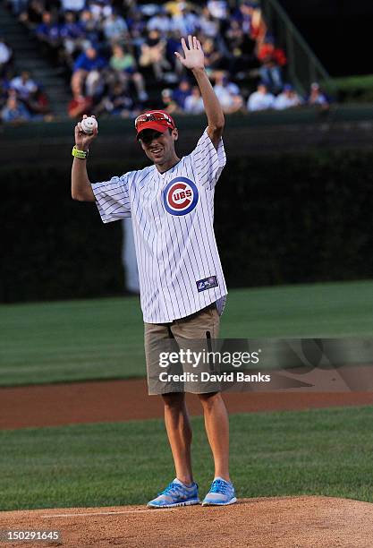 Olympian Dathan Ritzenhein throws out the first pitch before the game between the Chicago Cubs and the Houston Astros on August 14, 2012 at Wrigley...