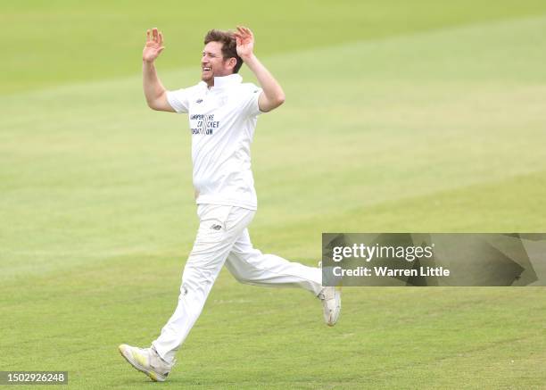 Liam Dawson of Hampshire celebrates dismissing Luke Hollman of Middlesex caught by Mhammed Abbas bowls during the LV= Insurance County Championship...