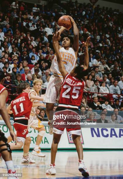 Latina Davis, Guard for the University of Tennessee Lady Volunteers attempts a jump shot to the basket over the blocking Kedra Holland, Guard for the...