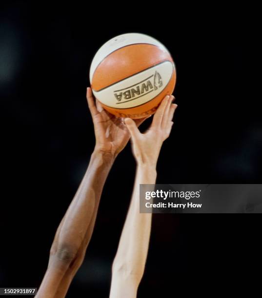 Detail view of the hands of Lisa Leslie, Center for the Los Angeles Sparks and Elena Baranova of Kyrgyzstan and Forward for the Utah Starzz reaching...