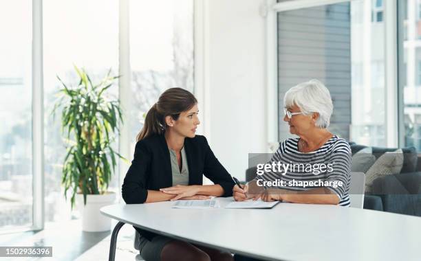 life insurance paperwork, old woman and financial advisor with pension plan and money management. future planning, female people in office with legal documents, retirement talk and policy contract - finance talk stockfoto's en -beelden
