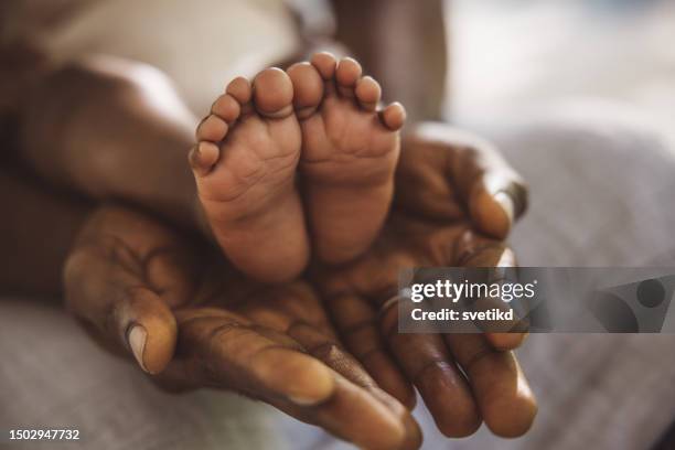 handle with care - black male feet stockfoto's en -beelden