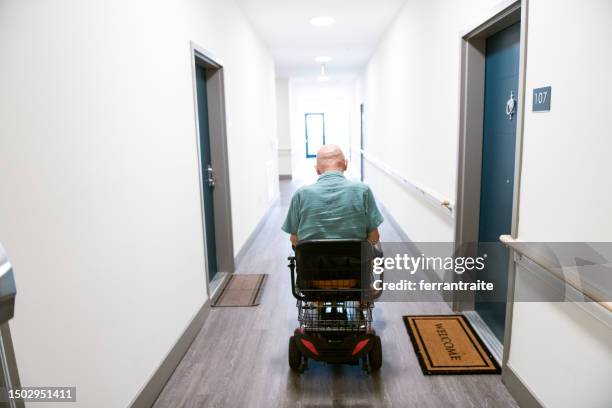 amputee rides a mobility scooter - affordable housing stock pictures, royalty-free photos & images