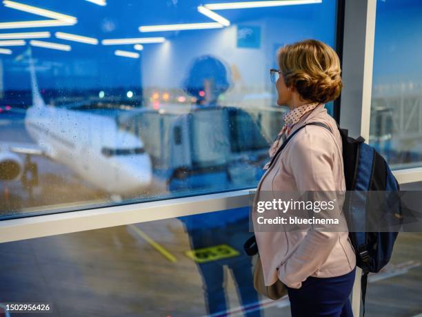 woman waiting for her flight in airport lounge - white jacket stock pictures, royalty-free photos & images