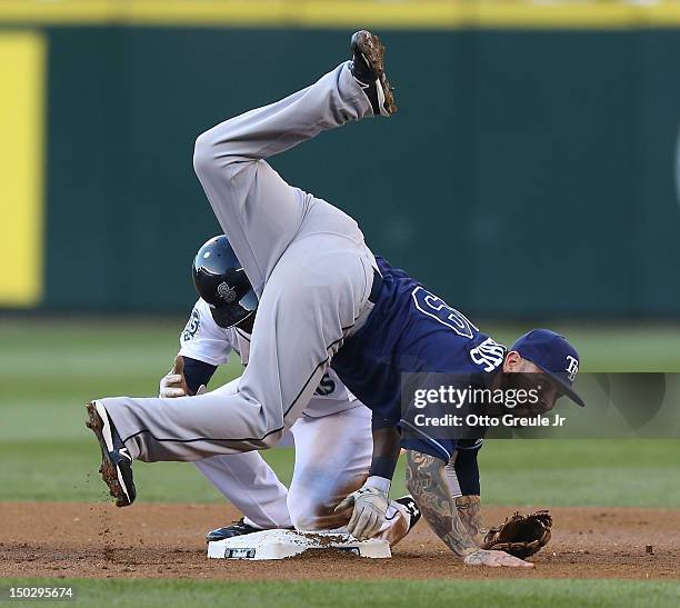 Second baseman Ryan Roberts of the Tampa Bay Rays turns a double play over Trayvon Robinson of the Seattle Mariners at Safeco Field on August 14,...