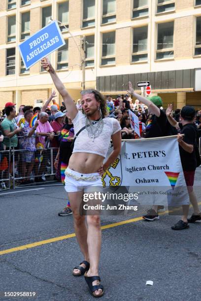 marcher from anglican church celerating at the 2023 pride toronto parade on june 25 - anglican stock pictures, royalty-free photos & images